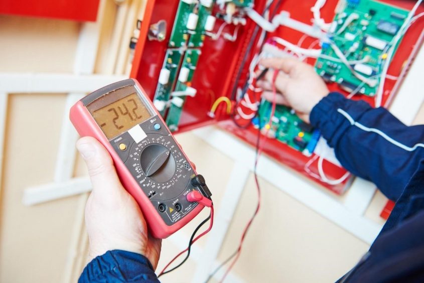 Electrician inspecting circuit breaker