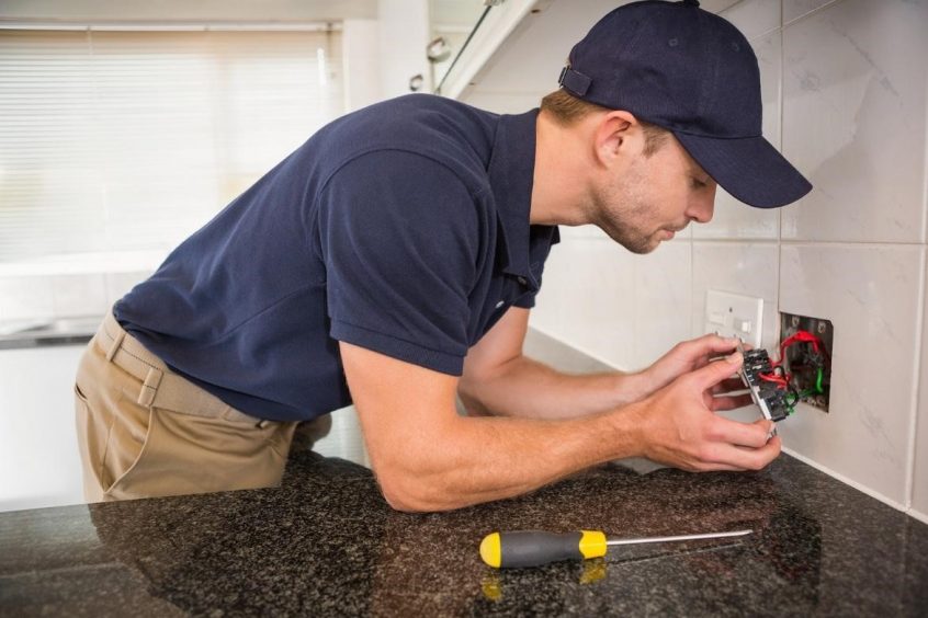 Electrician fixing outlet