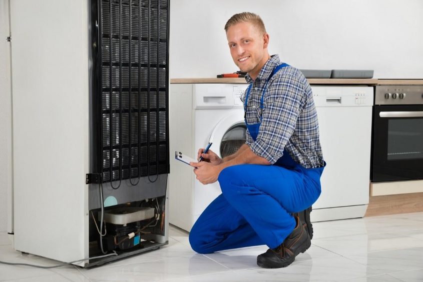 Electrician working on a refrigerator